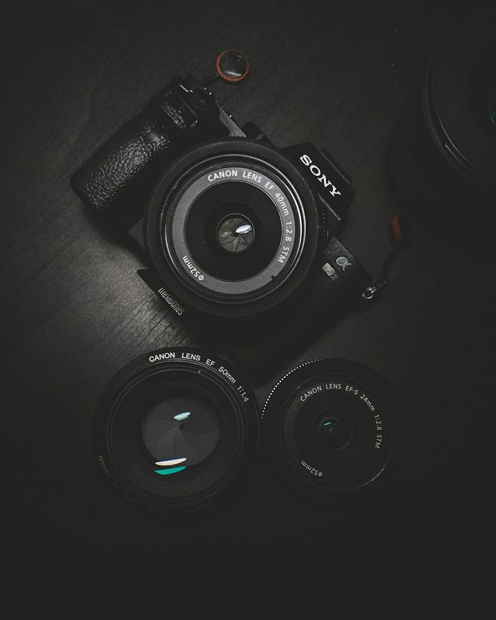 Camera and lenses on a dark surface